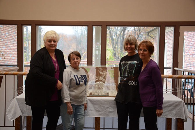 (From left) Vicki Albert of Mount Vernon, Faith Chudzik of Mason Neck, Rita Stankwitz of Clifton and Connie Myers of Springfield decorate the Pohick Church office in preparation for the Christmas Mart.