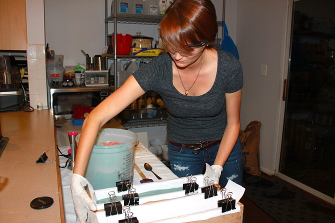 Brooke Goad smooths the soap into the mold after making a batch. Brooke is a co-owner of The Soap Engineers.
