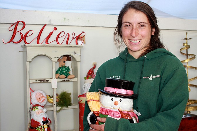 Laura Murray, State Gardens co-owner, poses with a snowman cookie jar for sale during the holiday season.
