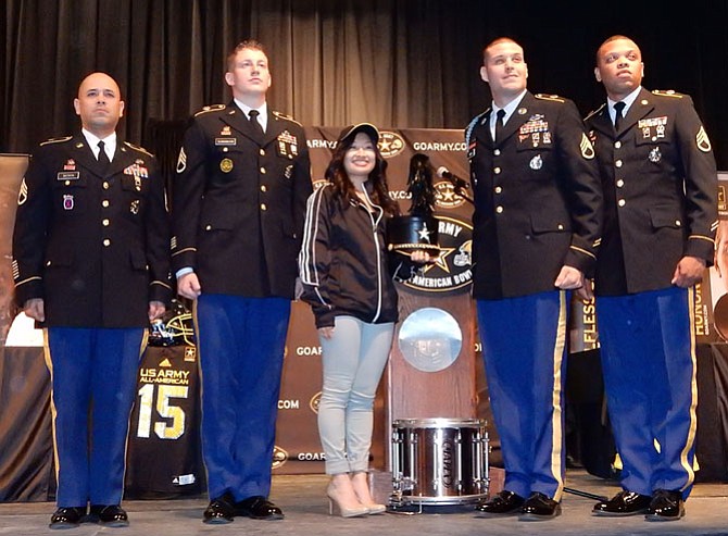 Surrounded by (from left) Staff Sgts. Marcos Batista, Joseph Clinkenbeard, Joshua Smith and Jeffery Wallace, Mari Takeda wears the Army All-American Marching Band jacket and cap.