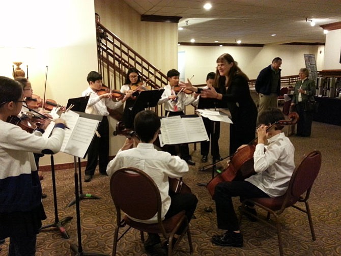 Members of the Liya Ensemble warm up before performing for the Virginia School Board Association’s Convention in Williamsburg on Nov. 19. These fifth and sixth graders attend Spring Hill Elementary School and were chosen by competitive audition.
