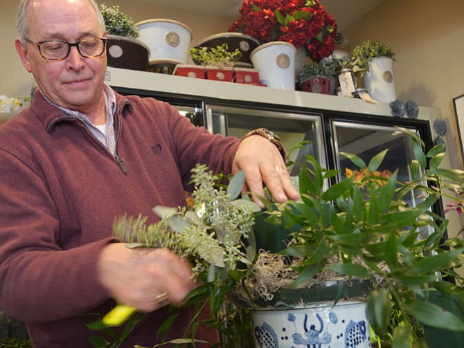 Scott Marchand puts the greens in first on his centerpiece floral arrangement of fall tones at Patina on Franklin Street.
