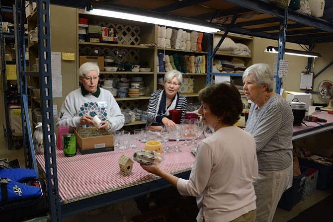 (Clockwise from top left) ECHO volunteers Pat Norton of Springfield, Eileen McGirl of Burke, Patsy Maddox of Fairfax and Jean Chandler of Burke assess and sort donated kitchen wares.