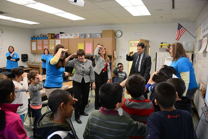 Hybla Valley Elementary School students in Megan Sidari’s (right) second grade class teach Virginia Secretary of Education Anne Holton (rear left), FCPS School Board Chairman Tammy Derenak Kaufax (rear center) and 44th District Delegate Scott Surovell (rear right) their “Shark Attack” song.
