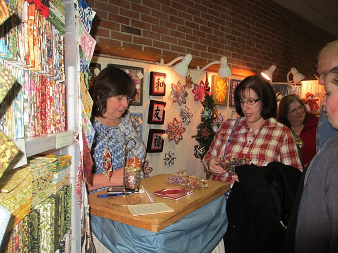 Customers line up to buy hand-crafted fabric holiday ornaments and home accessories.
