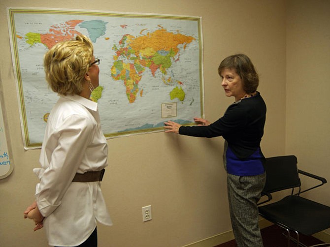 Patricia DePuy and Marcia D’Arcangelo pinpoint new countries, previously unheard of, where immigrants have come from to join the New Neighbors ELL program held in donated space at the Christ Church’s Fowler Center. 
