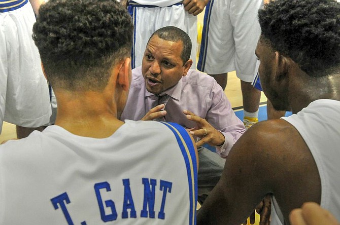 Wakefield boys’ basketball coach Tony Bentley talks to the Warriors during their 74-46 win over T.C. Williams on Dec. 5.