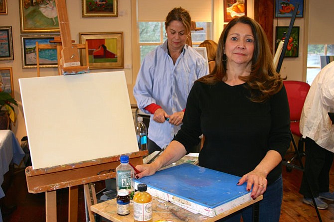 Founding member and co-owner of Artists on the Green Gail Péan sets up her canvas for the oil painting lesson taught by artist Trisha Adams.
