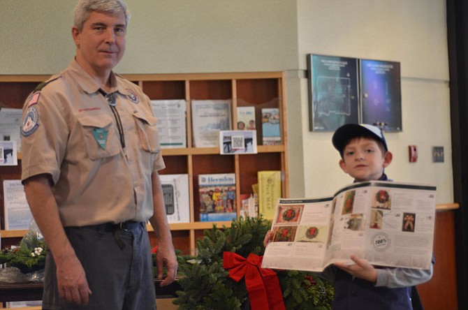 Cub Scout Pack 157 leader Barry Dresdner with Cub Scout Michael Fullerton helped sell wreaths at the Herndon Annual Arts and Crafts Show on Sunday, Dec. 7.