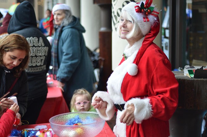 Reston resident Patricia McIntyre helped operate a crafts table at the 2014 “Jingle on Lake Anne Plaza” in Reston.