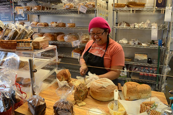 Mali Soderborg of Fairfax cuts a free sample slice of Extreme Cinnamon bread for a customer at Great Harvest Bread Company in Burke.