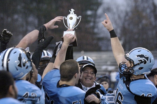 Members of the Centreville football team celebrate after winning the 6A North region championship on Dec. 6. The Wildcats beat Westfield, 21-17.