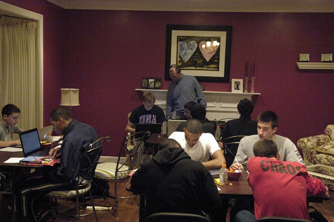 After dinner, it's time for work during a weekly study hall for Herndon High School student/athletes at head basketball coach Gary Hall's home in Reston.

