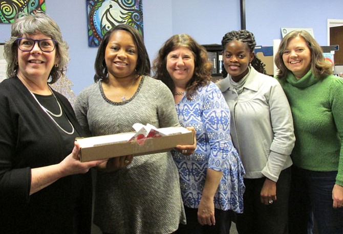 (From left) Combined Properties' Linda Dreyer presents grocery gift cards to ODB Holiday Program Manager Dawn Sykes, with Holiday Program Coordinator Stella Roberts, Holiday Data Coordinator Dee Osei-Boateng and Executive Director Lisa Whetzel. 
