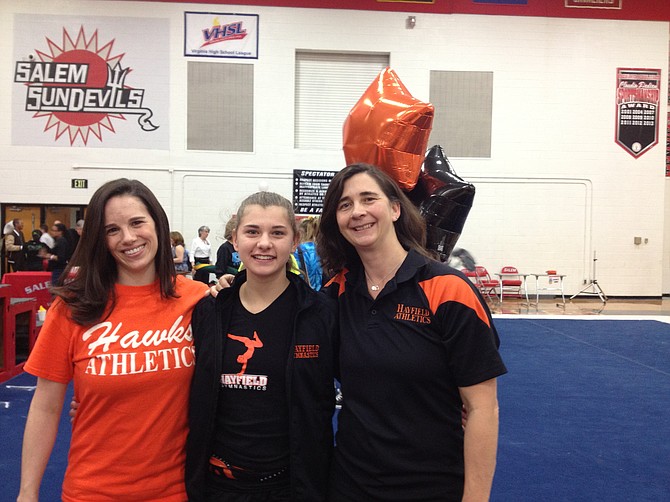 Hayfield’s Molly Overstreet, middle, is a two-time VHSL state champion gymnast. Her mother, Kristin Overstreet, right, is an assistant coach with the Hawks. Also pictured is Hayfield head coach Michelle Pennow.