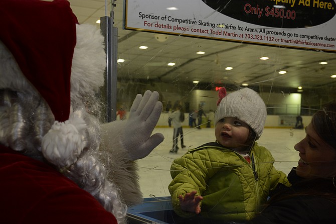 Quinn (center) and Wendy Dewindt of Arlington get face time with Santa at Fairfax Ice Arena. Longtime Burke resident Wendy brought her family to the event with her father, Burke Centre resident Mark Wagner.
