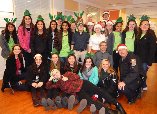 Chantilly and Centreville high-school students, teacher Betty Simmons (kneeling on left) and MPO Wayne Twombly (kneeling on right) brought joy to the Hanley Shelter children.
