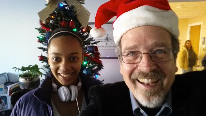 At the Christmas party, the Rev. Keary Kincannon in his Santa hat poses with congregation member Brianna Ford.
 
