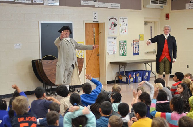 Historical re-enactors Bill Barker and Richard Schumann portrayed Founding Fathers Thomas Jefferson and Patrick Henry in January at several FCPS elementary schools in Reston and Herndon, VA. In this photo they take questions from students at Dranesville Elementary in Herndon.