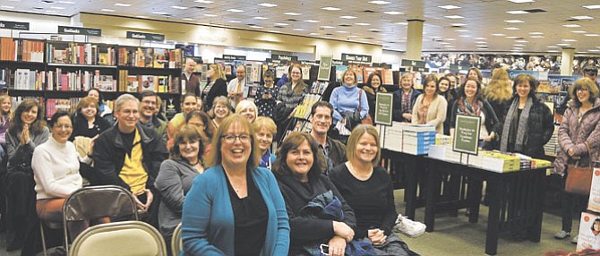 (Center, from left) Sherry Harris, Maureen Espizito and Sue Carlin sit with friends and family of Harris at the launch of her book “Tagged For Death” in the Fairfax Barnes & Noble.
