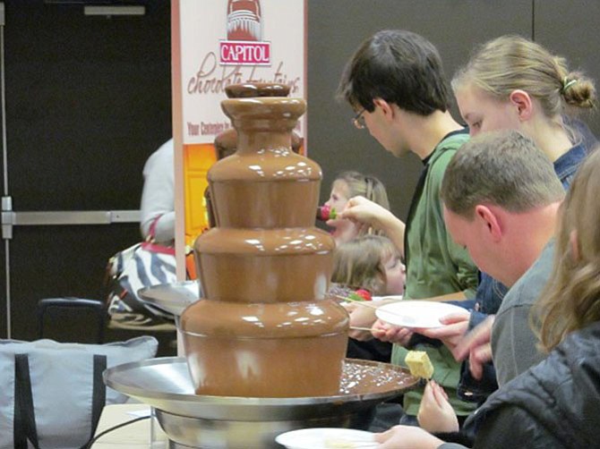 Visitors enjoy a chocolate fountain from Capitol Chocolate Fountains in a past McLean Chocolate Festival. This year’s festival will be Sunday, Jan. 25 at McLean Community Center.