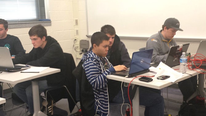 From left: Marshall Academy students Paul Benoit, 17; Joshua Shepherd, 18; Khang Lieu, 18; Jacob Walters, 17; and Michael Bailey, 17, won first place in the state round and ranked fifth overall in the nation in the CyberPatriot VII Competition. After Saturday’s regional competition, these FCPS students ranked third in the nation.
