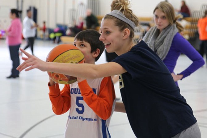 Sarah Roemer works on shooting drills with a Special Olympics athlete.