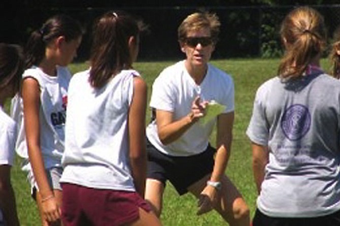 “Fit 2 Finish” author, coach, consultant and speaker Wendy LeBolt gives some instruction to a girls youth soccer team.
 
