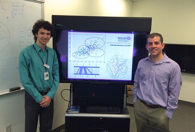 Eduard Danalache, senior at TJHSST, and Dr. Jesus Caban, chief of Clinical and Research Informatics at the National Intrepid Center of Excellence, at work on a project dealing with mild-traumatic-brain-injury clustering.
