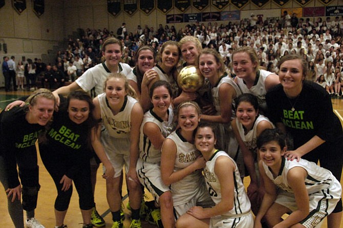 The Langley girls’ basketball team poses with the Rotary Cup after beating McLean on Jan. 23.