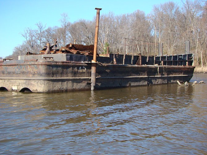 A wrecked barge in Belmont Bay once carried materials for constructing the Fairfax Yacht Club.
