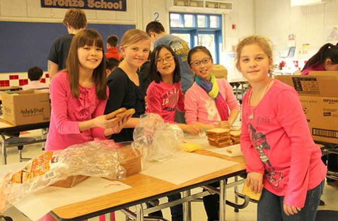 Churchill Road fourth graders Mia Aikman, Isabella Scott, Aoi Yanase, Emma Yang and Caroline Wicker formed an assembly line to make sandwiches for Martha’s Table, in Washington, D.C. 
