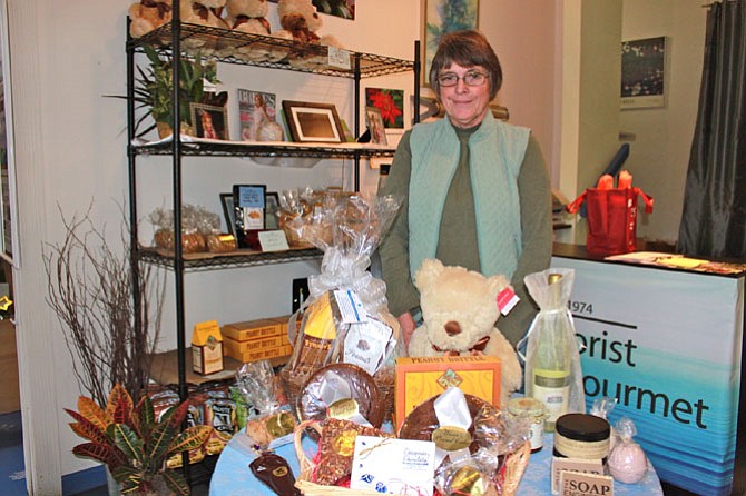 Linda Fuller, owner of Lake Anne Florist, showing off her wares in December.
