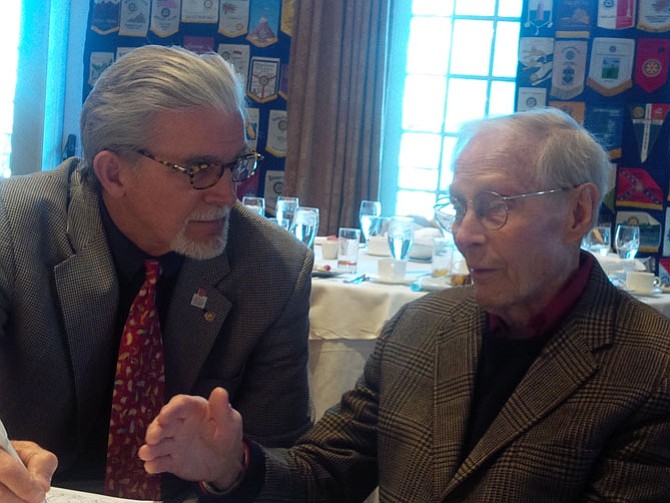 Dr. Robert Wineland, right, talks with Tom Roberts about his experience during the Battle of the Bulge at a recent Alexandria Rotary Club meeting.
