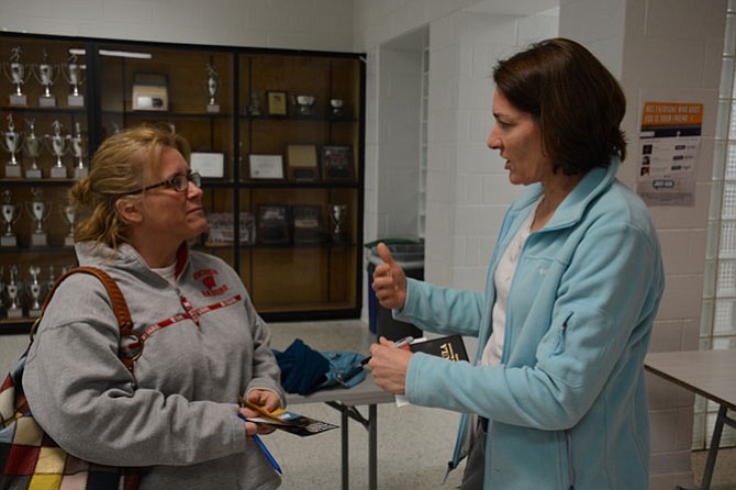 Amy DiGiulian of Springfield (left) and Mary Moran (right) of Springfield meet following the human trafficking forum at West Springfield High School Jan. 28.

