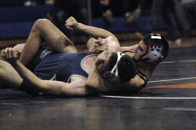 McLean grappler Conor Grammes, right, pinned his opponent in the 152-pound final, giving the Highlanders the Conference 6 championship on Feb. 7 at Hayfield Secondary School.