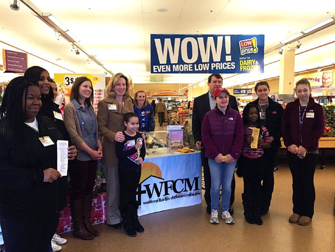 (From left) Stephanie Oni and Lakeshia Lewis from Fairfax County government, Lauren Sterling of Western Fairfax Christian Ministries, U.S. Rep Barbara Comstock (R-10), Chantilly High School volunteer Keaira Baker, Supervisor Pat Herrity (R-Springfield) and Chantilly volunteers Lauren Zarbo and Kemi Oni help kick off the Stuff the Bus event at the Giant in Clifton. 
