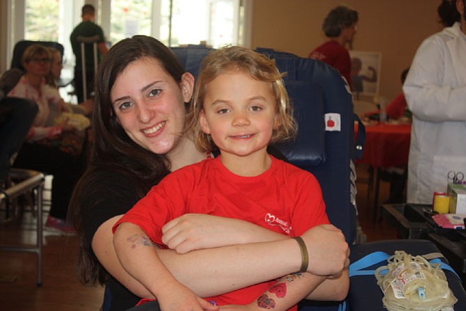 Robinson sophomore Madeline Dozier waits to donate blood for the first time, with the drive’s namesake Sadie Lauer.
