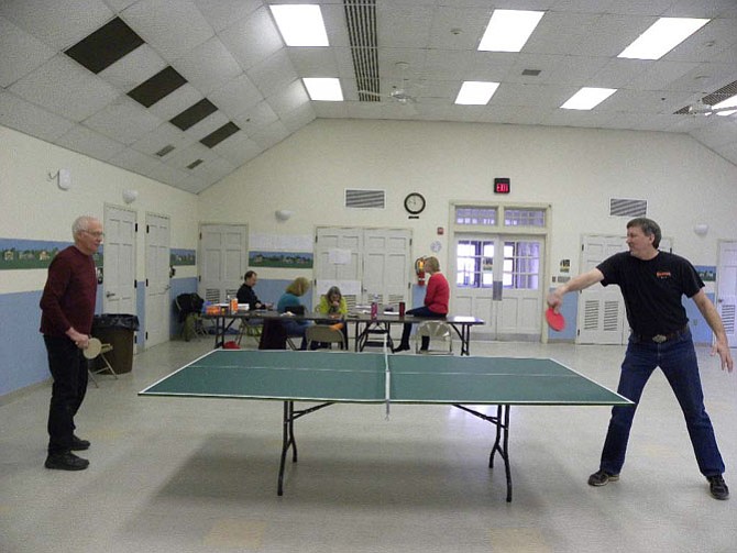 Participants of the Clifton Betterment Association’s first ping pong tournament warm up before the adult competitions begin at the Clifton Town Hall on Saturday, Feb. 7.
