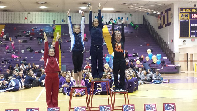 Washington-Lee senior Sophie Hatcher, second from right, won the 6A North region all-around title and Yorktown freshman Bella Kane, second from left, finished runner-up on Feb. 11.