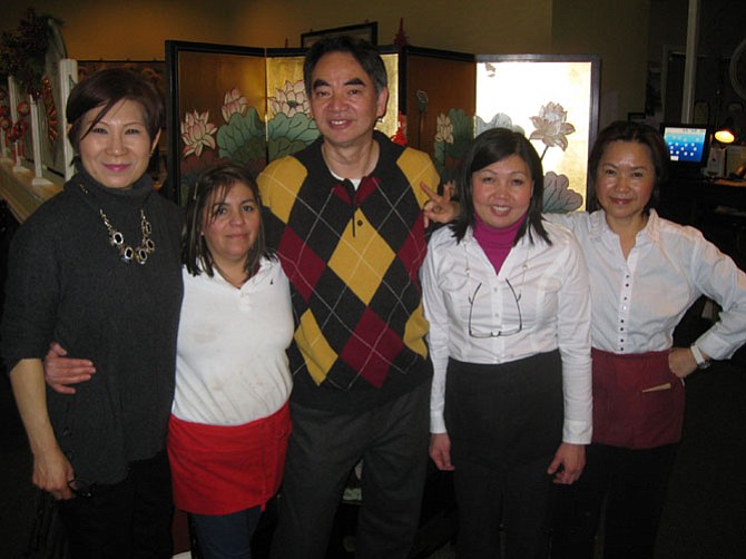 Asian Grill owners Darrin Hoe and his wife Jenny with some of their staff.