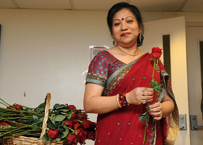 Sumitra Barua presents roses to the guests at the Valentine’s Day concert.

