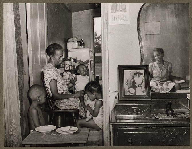 In this 1942 photograph by the late Gordon Parks, Ella Watson (left) sits with three children; her adopted daughter appears on the right, reflected in a mirror. Parks is one of the African-American artists Dr. Evie Terrono will discuss on Feb. 19 at the Workhouse Arts Center.
