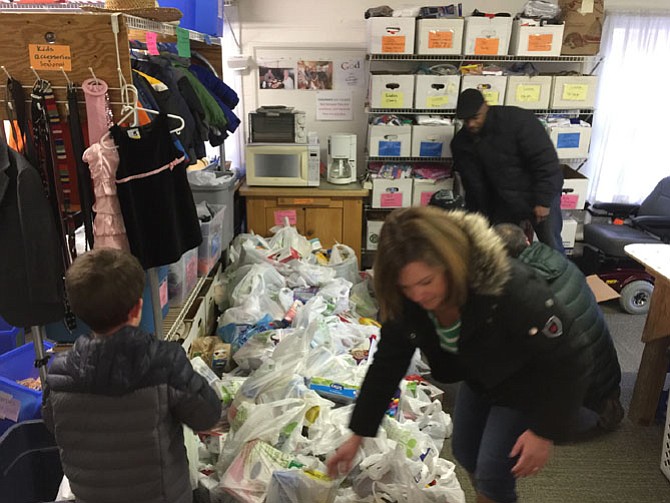 Koinonia volunteers begin to sort through the 1,200 pounds of food donated through the Feb. 14 “Stuff the Bus” event.
