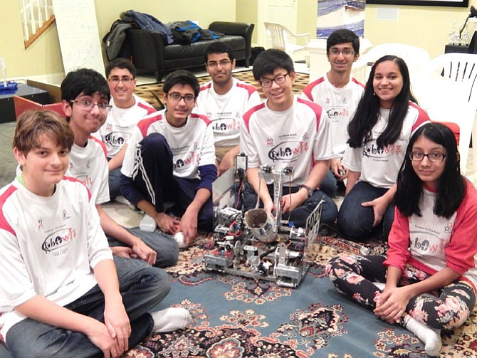 Surrounding their robot are (from left) Cedric Bernard, Shomik Ghose, Saarthak Sethi, Josal Patel, Abhishek Mishra, Jami Park, Adarsh Kulkarni, Radhika Agrawal and Anushka Jain.
