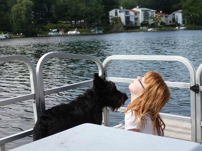 Angus, the Scottie for all seasons! Angus is a 5-year-old Scottish Terrier, born in Iowa and moved to Reston as a tiny 5-week-old puppy, to be with the Lovaas family. His closest friends are our 2 grandchildren, Joy and Cole. Here he is on Lake Anne, explaining the finer points of boating to Joy. --Frances Lovaas
