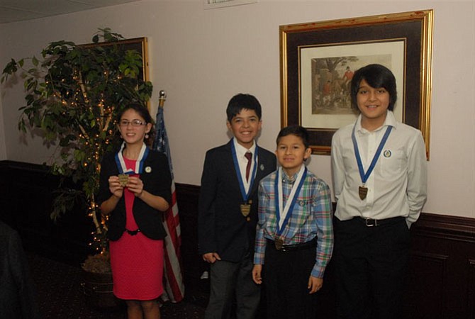 Canterbury Woods students,Yana Bugby,Brandon Reyes, Luis Pinto and Pranil Dhakal display their medals from their performances.
