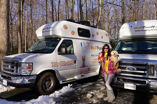 Marzi Sharifi of HoPPooH in Fairfax with her dogs and her mobile pet grooming vans. Sharifi recently acquired a second van for her growing business.