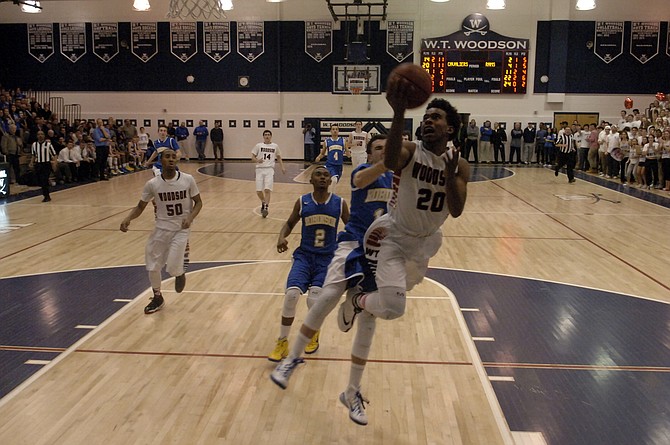 Eric Bowles, the Conference 7 Player of the Year, led Woodson with 27 points during the Cavaliers' 70-55 win over Robinson on Friday night in the opening round of the 6A North region tournament at W.T. Woodson High School.