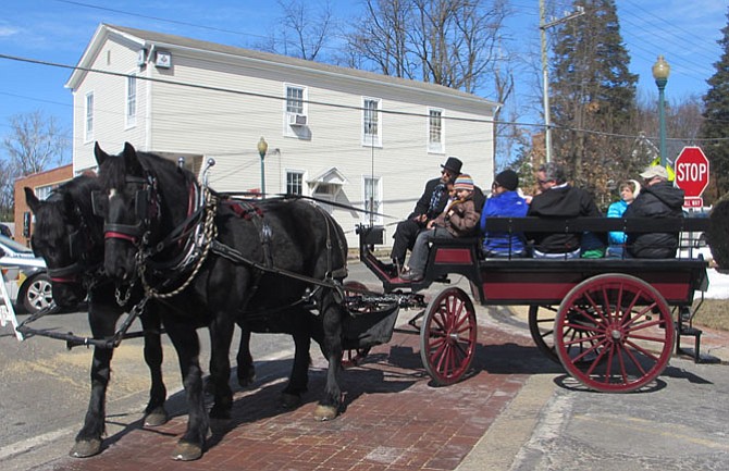 A horse-and-carriage took birthday guests along Mill Street.